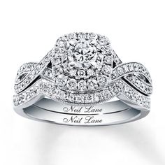 a white gold ring with diamonds on top and the words neil lane written in cursive writing