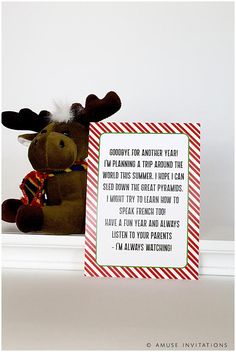 a stuffed moose is next to a christmas card