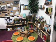 a room filled with lots of books on shelves next to a green carpeted floor