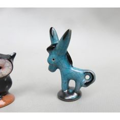 two small ceramic figurines sitting next to each other