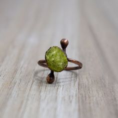 Natural Peridot Ring | Raw Peridot ring | August Birthstone Ring | Electroformed Jewelry | Organic Stone Jewelry | Handmade Ring Ring Size: US  : All Sizes Available Gemstone       : 11 X 10 MM Weight             : 3.00 gm Material           : Copper Polish               : Copper Antique Polish  . Contact us for wholesale prices. R I N G S https://www.etsy.com/in-en/shop/GemFormingStudio?section_id=22783374 B E A D S https://www.etsy.com/in-en/shop/GemFormingStudio?section_id=22828835 W A N D S Handmade Green Toe Ring, Handmade Green Promise Ring, Handmade Green Crystal Promise Ring, Handmade Green Birthstone Promise Ring, Handmade Peridot Rings As Gift, Handmade Peridot Rings For Gift, Adjustable Raw Stone Promise Ring, Minimalist Handmade Green Ring, Hand Forged Green Rings For Gifts