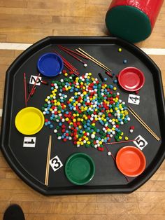 a child's play table with lots of colorful buttons and numbers on the tray