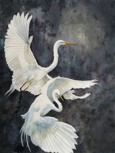 two white birds are flying in the sky