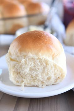 a close up of a piece of bread on a plate with other food in the background