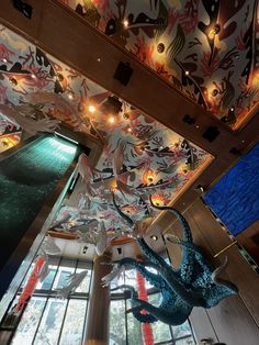 the ceiling is decorated with colorful paper flowers and fish sculptures, along with other decorations