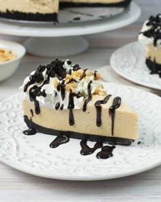 there is a slice of cheesecake with chocolate and whipped cream on the top, along with other desserts