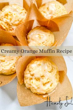 orange muffins with cream cheese frosting in wrappers