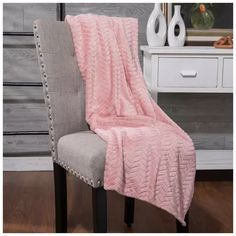 a chair with a pink blanket on it