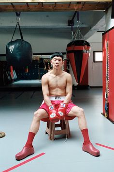 a man sitting in a chair with boxing gloves on