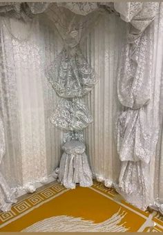 an elaborately decorated room with white curtains