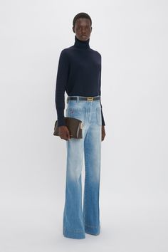 Tailored jeans are a hallmark of the Victoria Beckham brand and a signature silhouette in the house’s archive is the Alina Jean with its classic retro feel inspired by Victoria’s personal vintage denim collection. They feature seventies-style front and back patch pockets and are reimagined in a Bleach Wash for the new season evoking a relaxed, off-duty attitude. Styled with the Frame Belt In Midnight, Polo Neck Jumper & Victoria Clutch Victoria Beckham Alina High Waisted Jean In Light Summer Was Victoria Beckham Jeans, Tailored Jeans, Burgundy Clutch, Seventies Style, Tailoring Jeans, High Waisted Jean, Seventies Fashion, Denim Collection, Bleach Wash