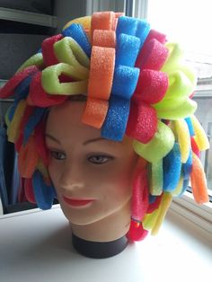 a mannequin head with colorful hair on it