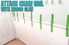 there are several pieces of tape taped to the wall next to a door that says attach chair rail with escool glue