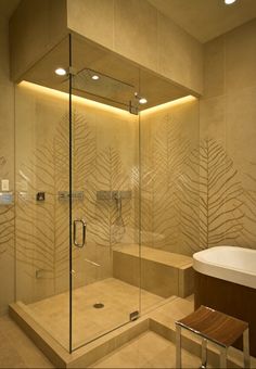 a bathroom with a walk in shower next to a white bath tub and wooden bench