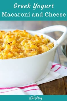 a white dish filled with macaroni and cheese on top of a wooden table