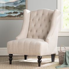 a beige chair sitting on top of a rug