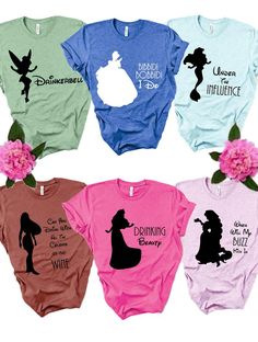 four different colored shirts with the silhouettes of disney characters on them and flowers in front of