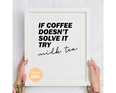 two hands holding up a framed poster with the words if coffee doesn't solve it try