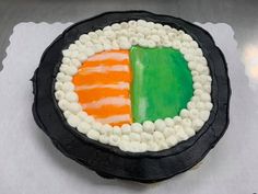 a cake decorated in the colors of ireland and irish flag is on a white tablecloth