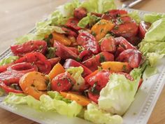 lettuce and tomato salad on a white plate