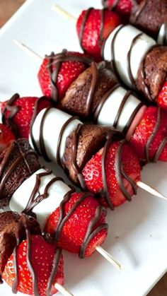 chocolate covered strawberries are arranged on skewers