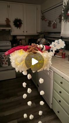 a kitchen decorated for christmas with candy and candies hanging from the ceiling in front of an oven