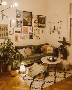 a living room filled with furniture and lots of pictures on the wall above it's coffee table