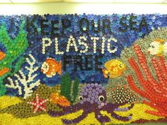 there is a sign made out of plastic bottle caps and beads with sea animals on it