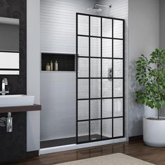 a bathroom with a sink, mirror and shower stall in the middle of the room