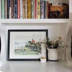 the bookshelf is full of books and vase with flowers