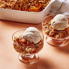 two dessert dishes with ice cream and fruit in them on a table next to a casserole dish