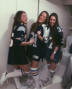 three girls are standing in the locker room