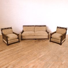 three pieces of furniture sitting on top of a hard wood floor in an empty room