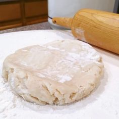 a doughnut sitting on top of a counter next to a rolling pin