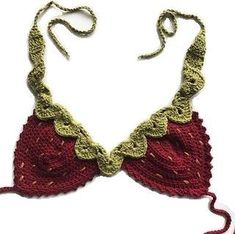 a crocheted red and green necklace on a white background with a string attached to it