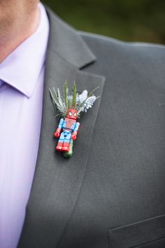 a man wearing a suit and tie with a boutonniere on his lapel