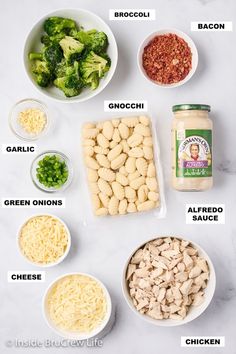 the ingredients to make broccoli salad laid out on a white marble counter top