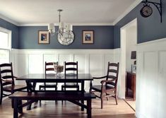 a dinning room table with chairs and a clock on the wall