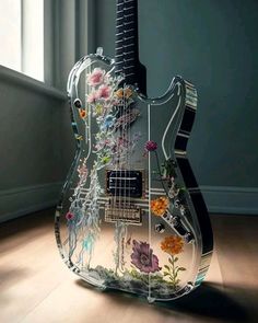 an electric guitar is decorated with flowers and other things on it's back end