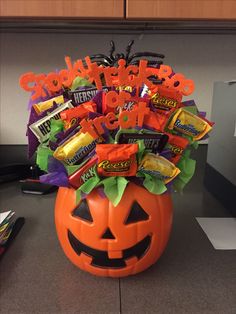 an orange pumpkin filled with candy and candies