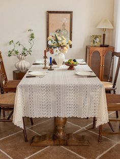 a dining room table with white lace on it