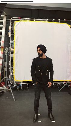 a man standing in front of a white backdrop