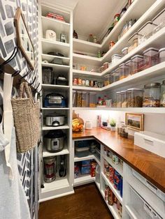 an organized pantry with wooden counters and shelves