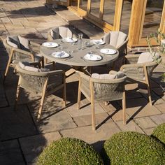 an outdoor dining table and chairs set up outside