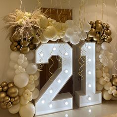 the number twenty is surrounded by balloons and streamers in gold, white and silver