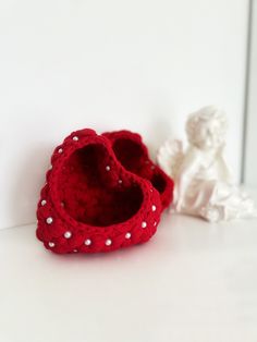 two small crocheted shoes sitting on top of a white counter next to each other