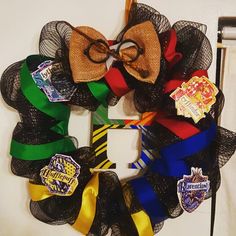 a harry potter wreath with hogwarts and pins