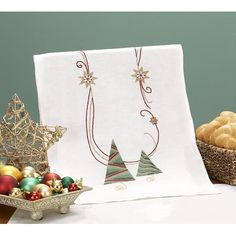 a table topped with christmas decorations and other holiday items next to a basket of cookies