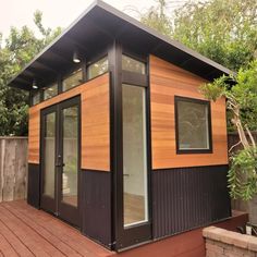 a small wooden building sitting on top of a wooden deck