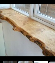 a wooden window sill sitting in front of a window